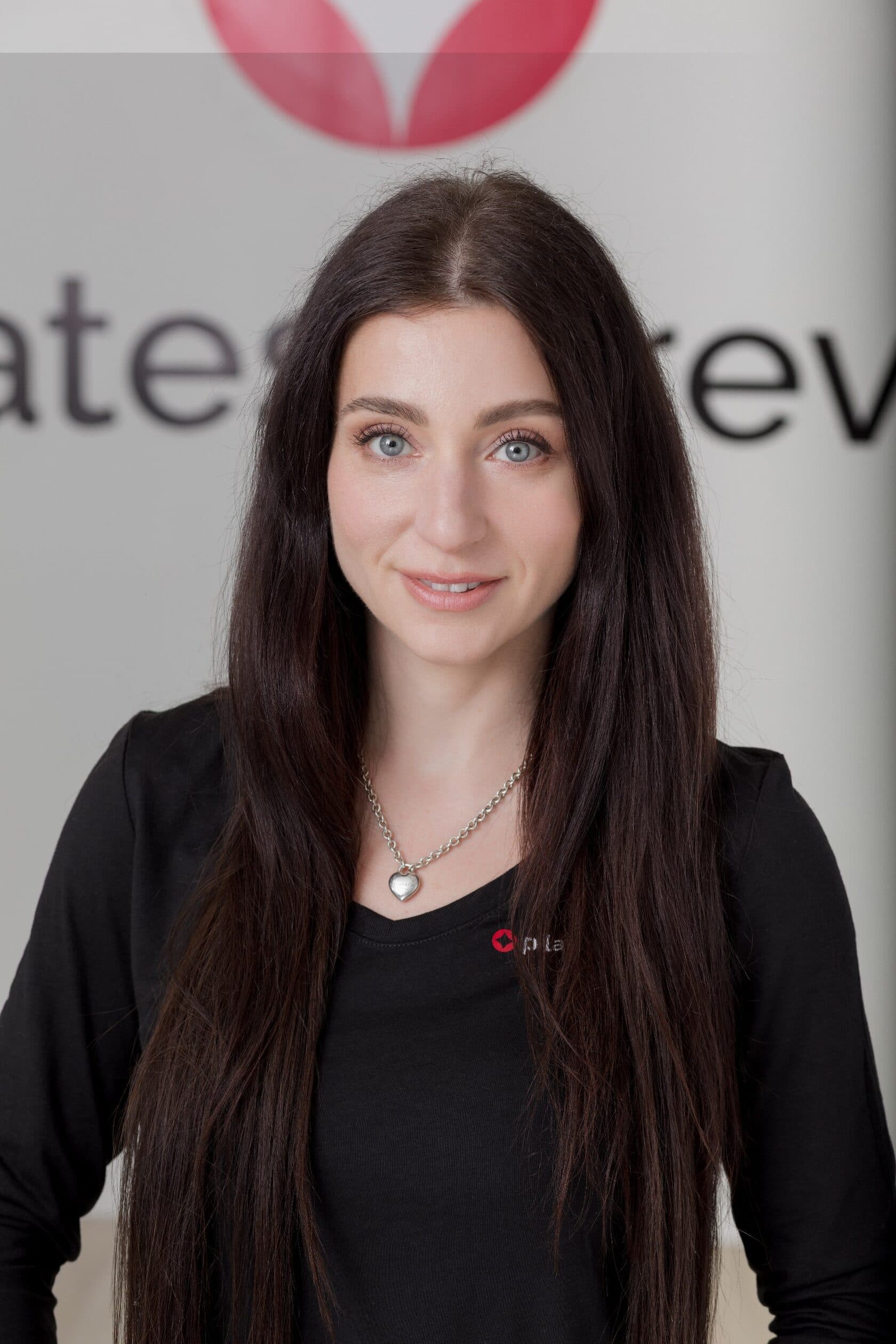 Alina Dovgal — founder of Pilates Forever, smiling headshot